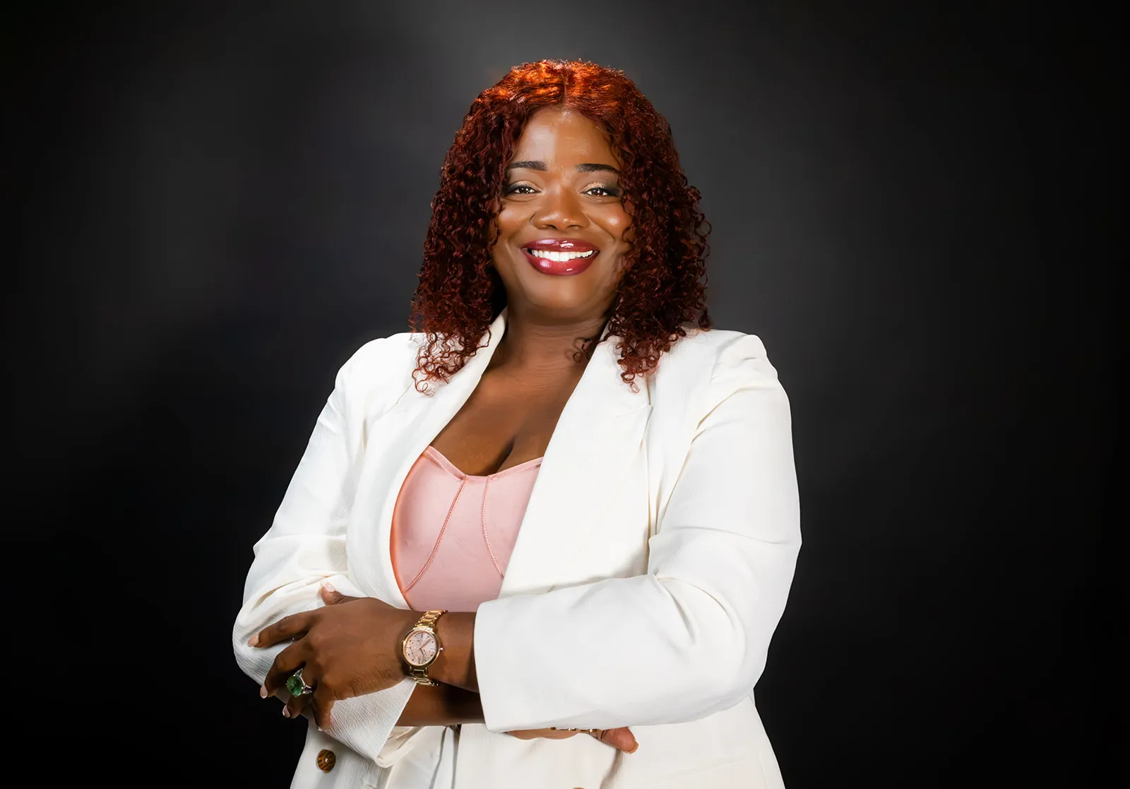 Latoya Reid, founder of ReiSpace, smiling with arms crossed.